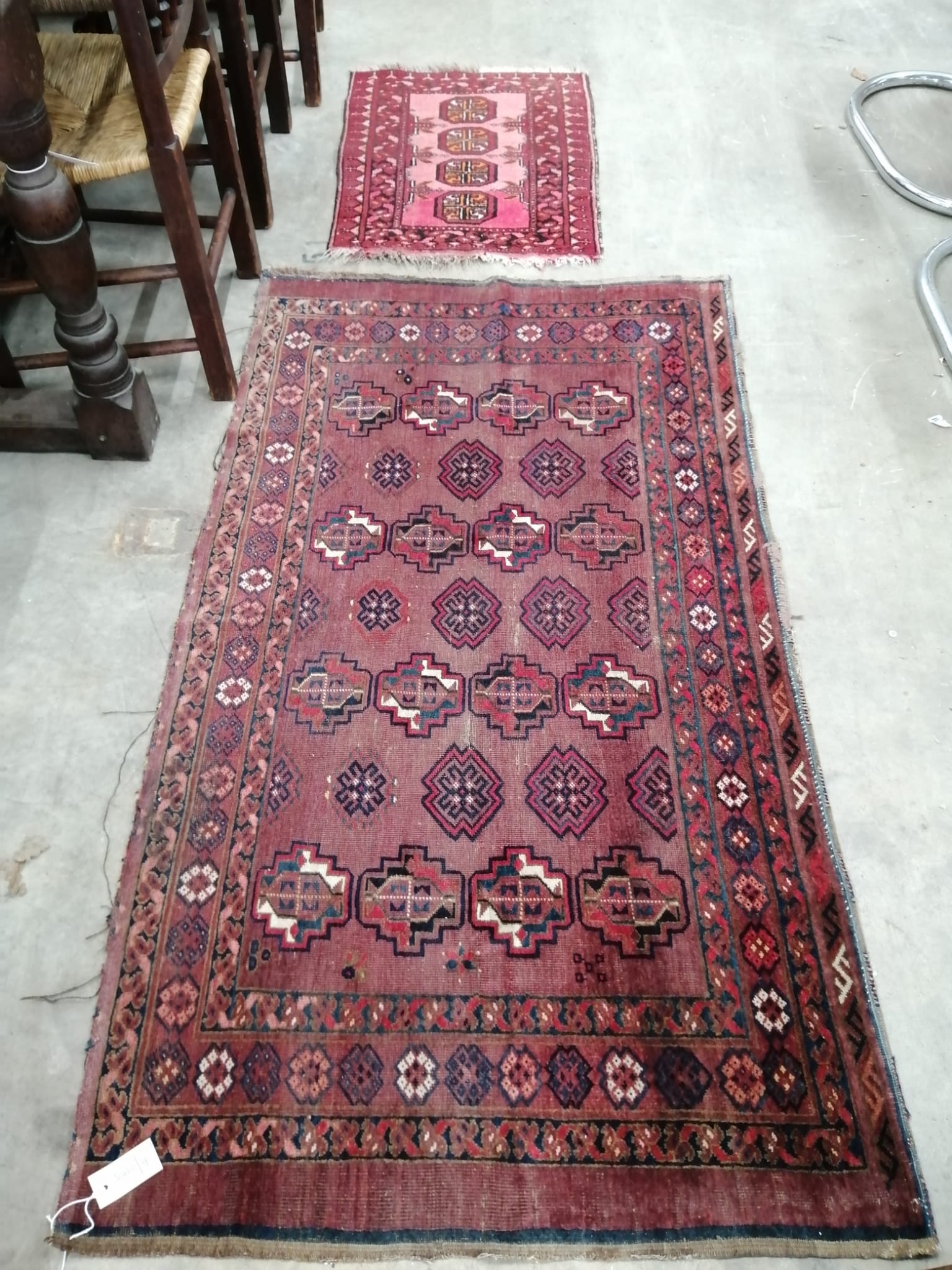 An antique Bokhara rug and one other, larger 160cm x 90cm.